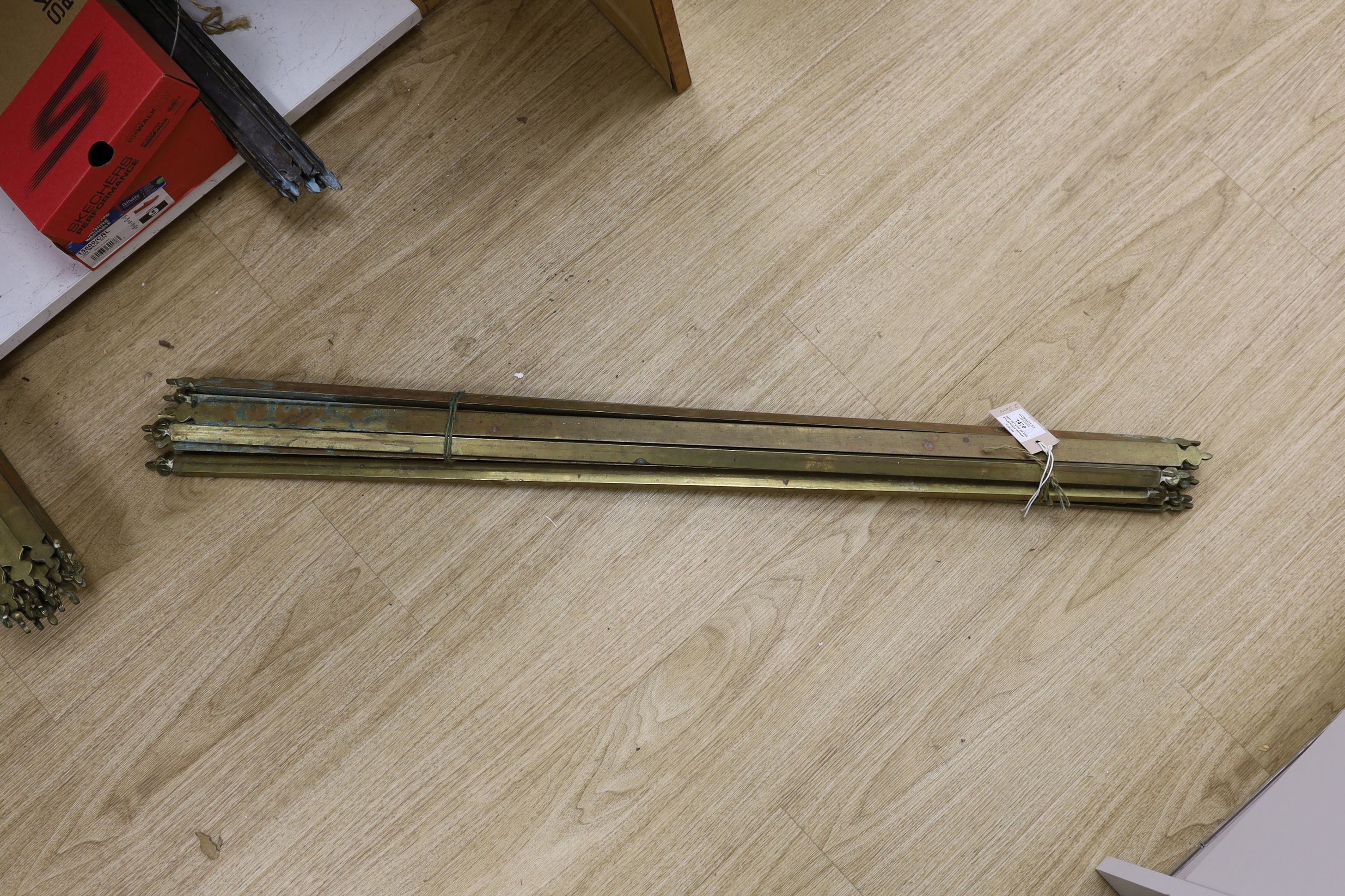 Two sets of brass stair rods with fittings.